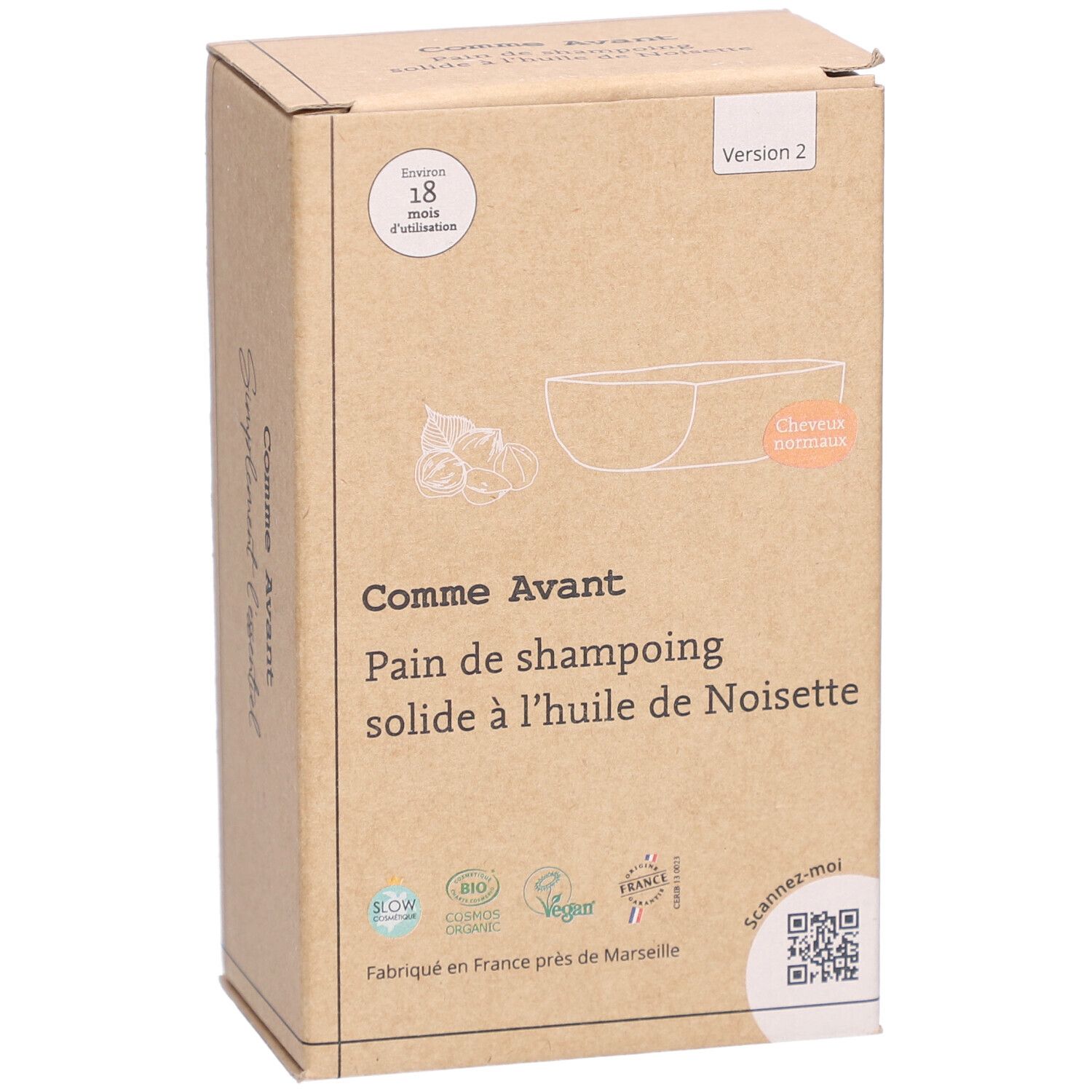 Kartonnen verpakking met productinformatie. Opschrift: Comme Avant, Pain de shampoing solide à l'huile de Noisette. Met illustratie.