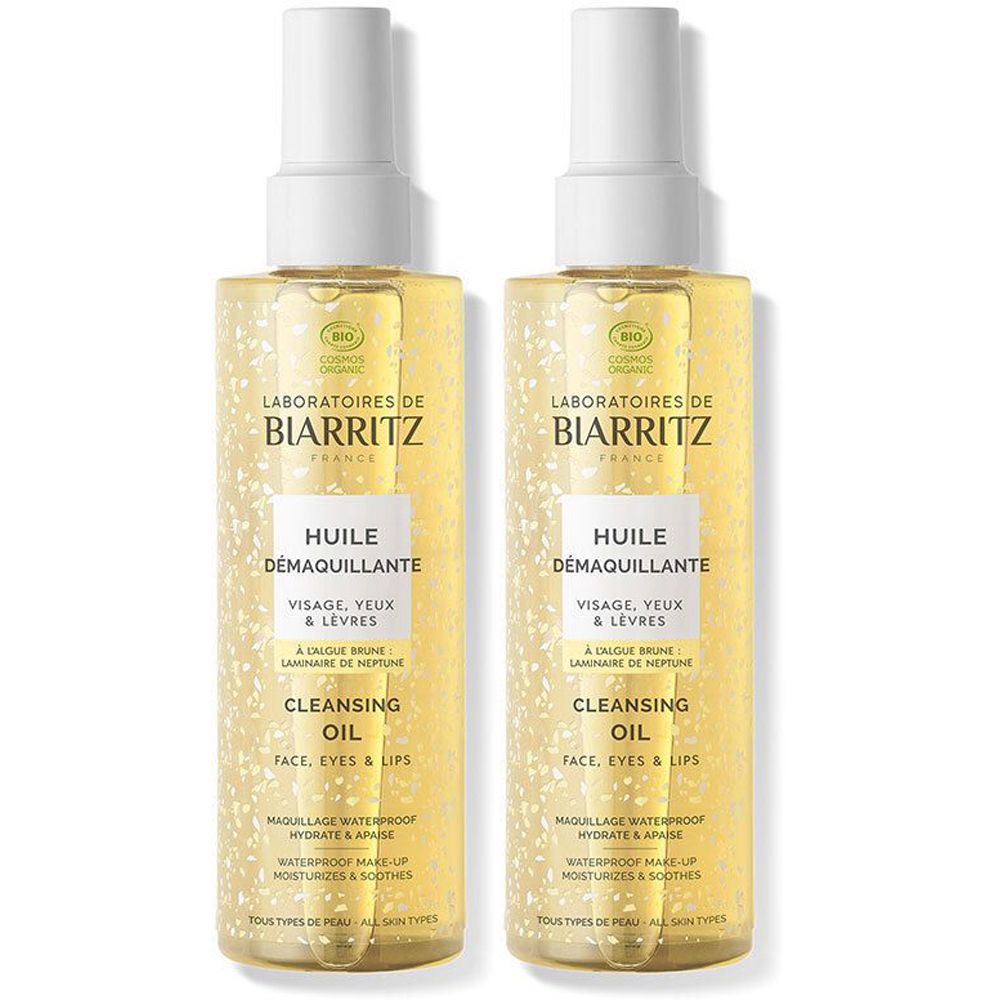 Twee flessen reinigingsolie. Opschrift: Laboratoires de Biarritz, Huile Demaquillante, Cleansing Oil. Voor gezicht, ogen en lippen.