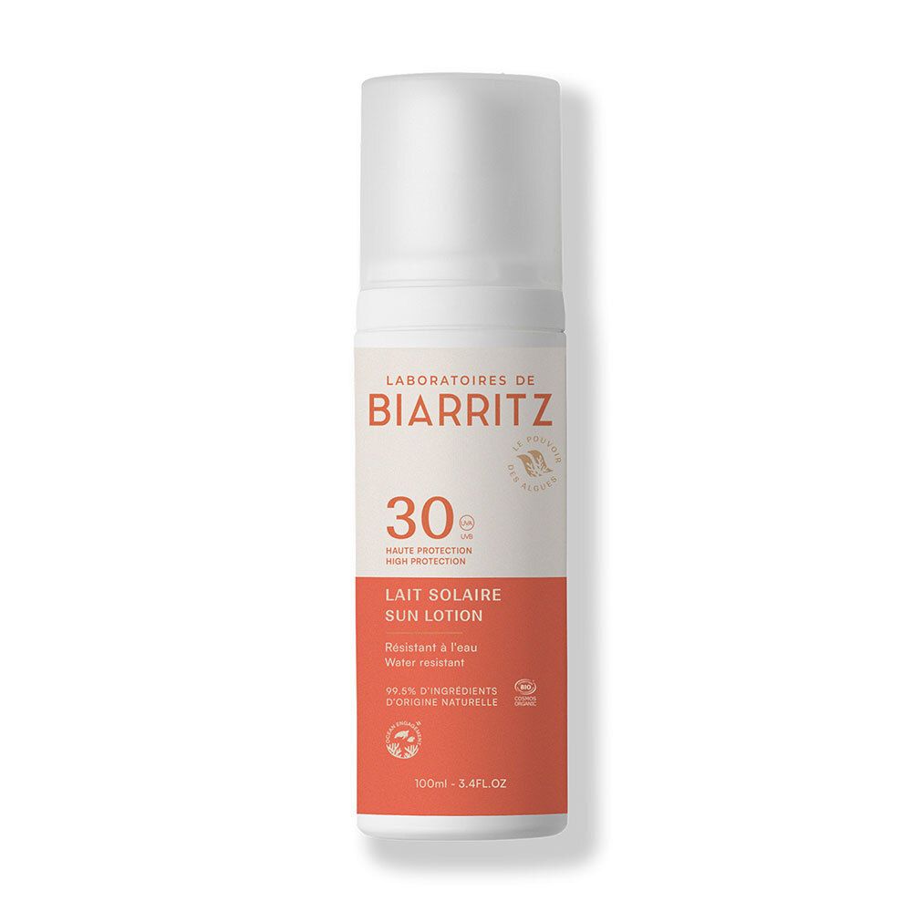 Flacon de lait solaire. Distributeur blanc, section orange avec texte. Marque: Laboratoires de Biarritz. Protection solaire 30.