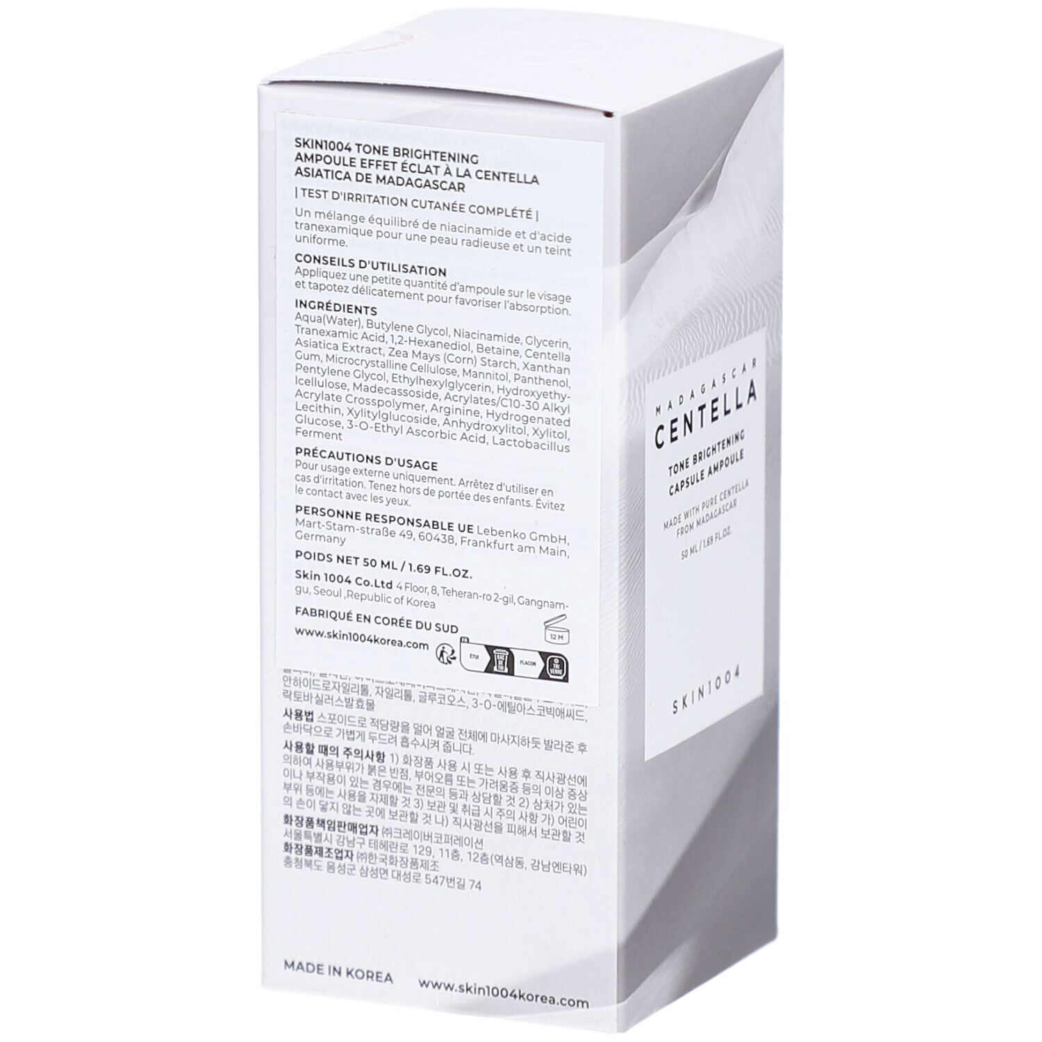 Witte verpakking met productinfo en tekst. Tekst: SKIN1004 Tone Brightening Ampoule. Ingrediënten en gebruik.