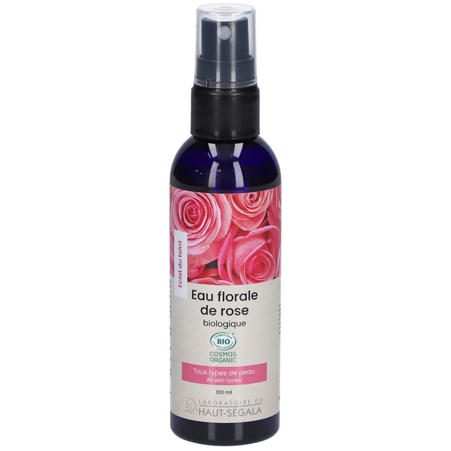 Blauwe transparante fles met verstuiver. Etiket met rozenmotief en tekst: Eau florale de rose biologique. Bio-certificering.