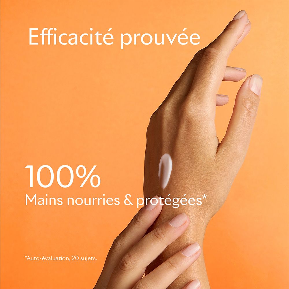 Hand met aangebrachte crème. Tekst: 100% Mains nourries & protégées. Oranje achtergrond.