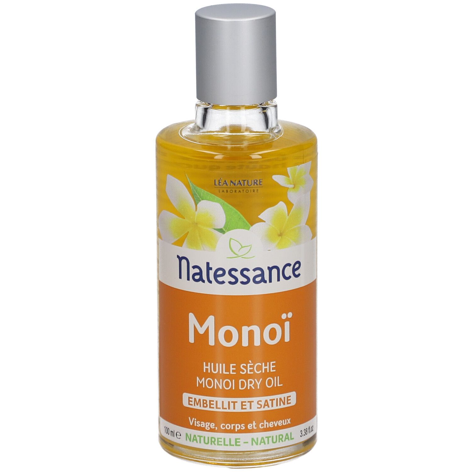 Flesje Natessance Monoï droge olie. Oranje etiket met witte bloemen. Zilveren dop.