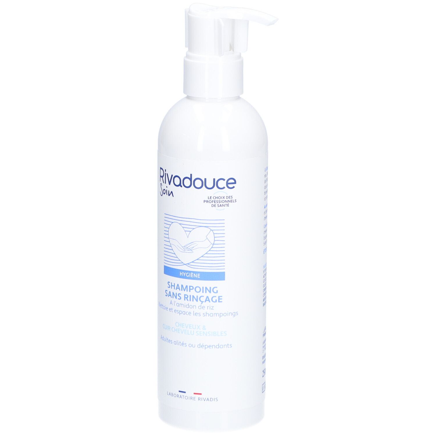 Witte fles met pomp. Opschrift: RIVADOUCE Soin, Shampoing Sans Rinçage. Hygiëneproduct voor volwassenen en afhankelijken.