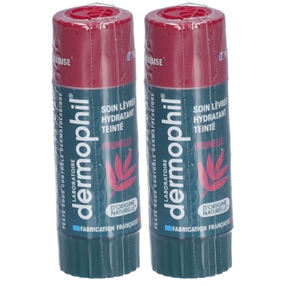 Twee lippenbalsemstiften verpakt in folie. Donkerrode dop, groene huls. Opschrift: dermophil, Soin Lèvres Hydratant Teinté.