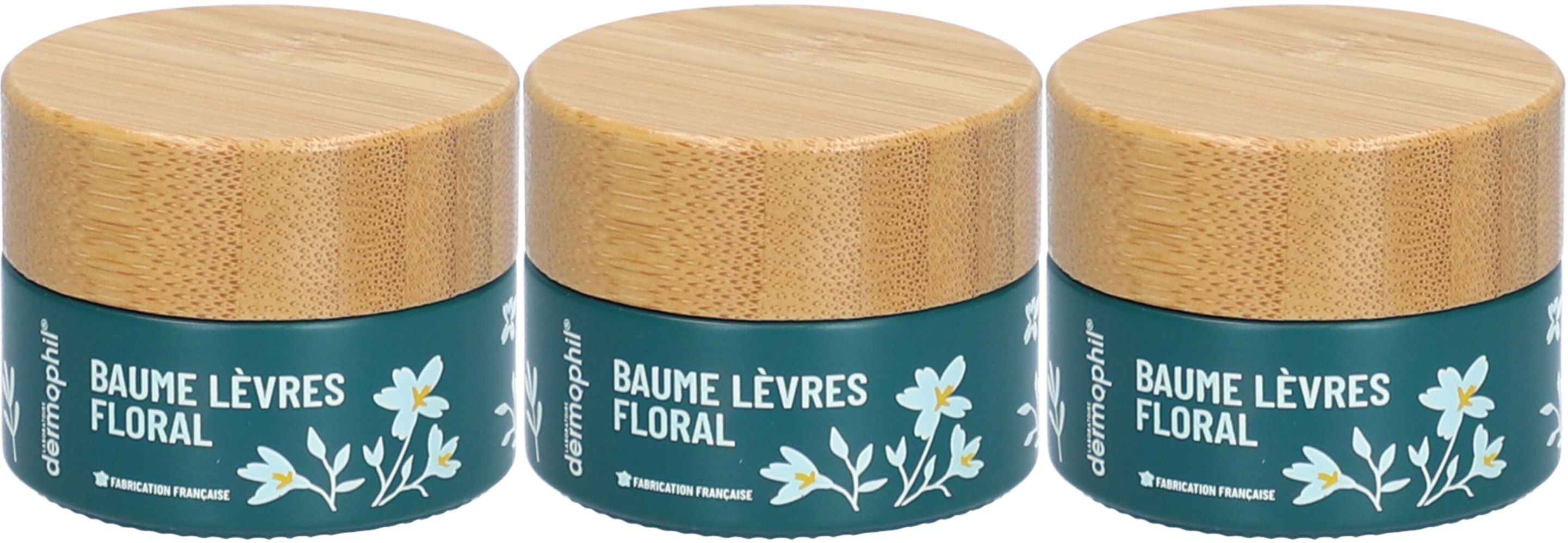 Trois pots de baume à lèvres avec couvercles en bois. Inscription: BAUME LÈVRES FLORAL. Récipient turquoise avec fleurs blanches. Marque: Dermophil.