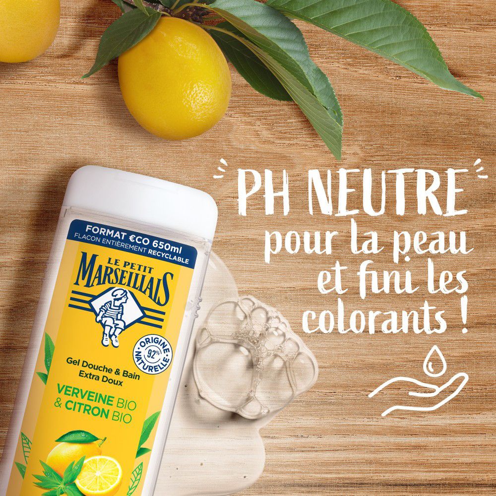 Flacon de gel douche à côté de mousse de savon et citrons. Texte: PH NEUTRE pour la peau et fini les colorants!