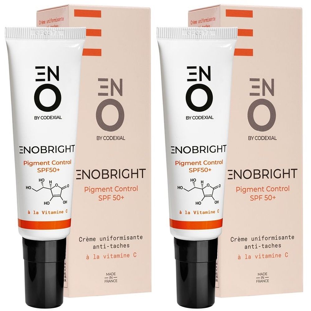 Twee tubes en verpakkingen van ENO Enobright Pigment Control SPF50+. Witte tubes met zwarte dop, dozen ernaast.