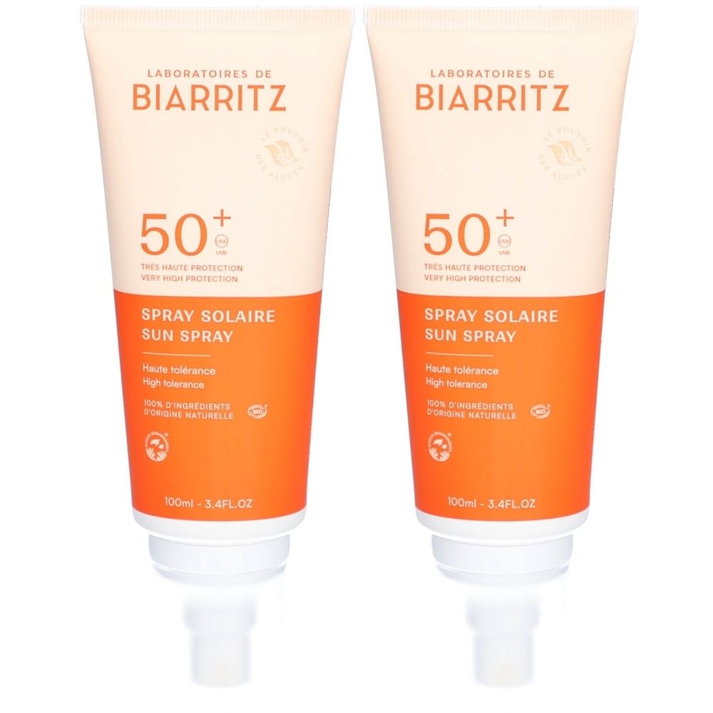 Deux tubes de spray solaire SPF 50+. Inscription: Laboratoires de Biarritz, Spray Solaire Sun Spray. Tube blanc avec section orange.