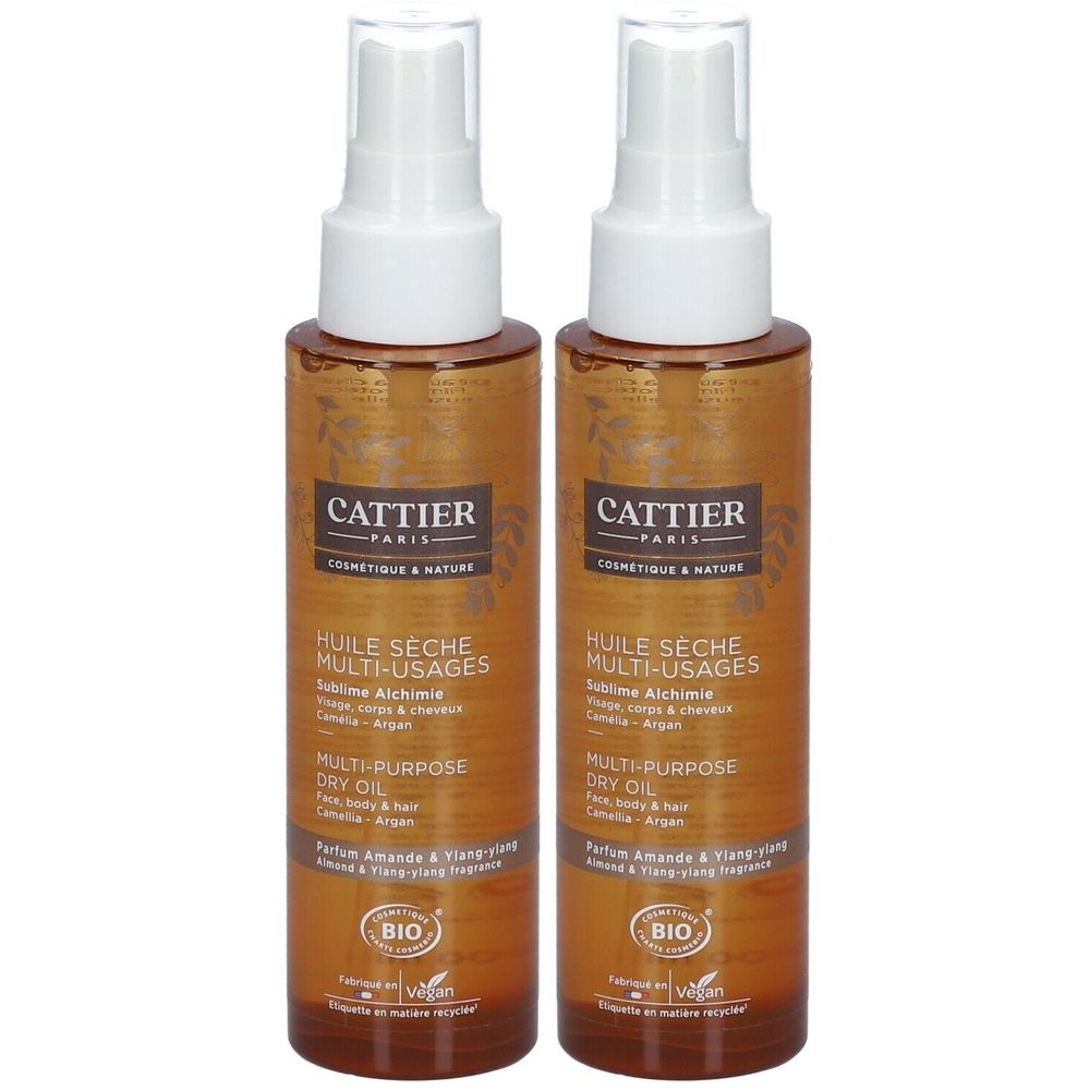 Deux flacons de Cattier Huile sèche multi-usages Sublime Alchimie. Flacons en verre brun avec vaporisateur blanc. Inscription : BIO, vegan.