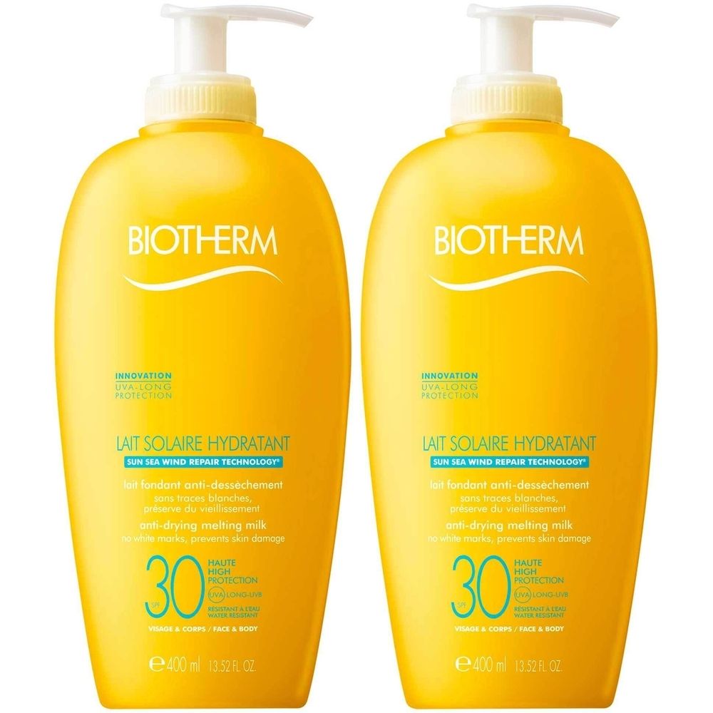 Deux flacons jaunes avec pompe. Inscription : BIOTHERM, LAIT SOLAIRE HYDRATANT, SPF 30. Lait fondant anti-dessèchement.