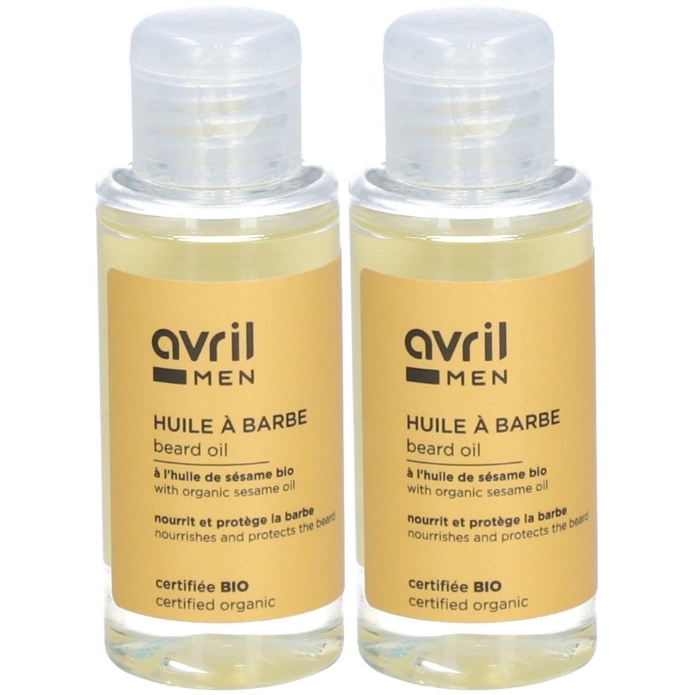 Twee flesjes baardolie. Opschrift: Avril MEN, Huile à Barbe, gecertificeerd BIO. Heldere vloeistof, gele label, transparante dop.