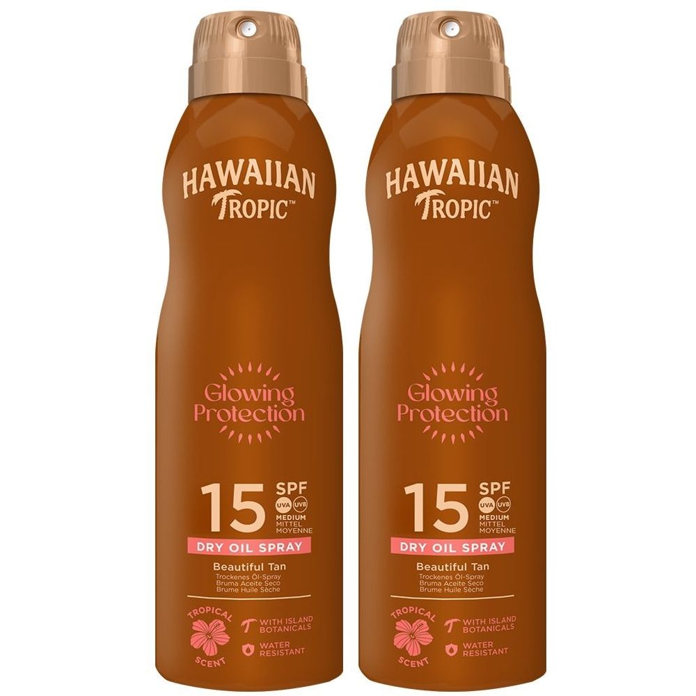 Twee bruine spuitflessen. Opschrift: HAWAIIAN TROPIC, Glowing Protection, SPF 15, Dry Oil Spray.