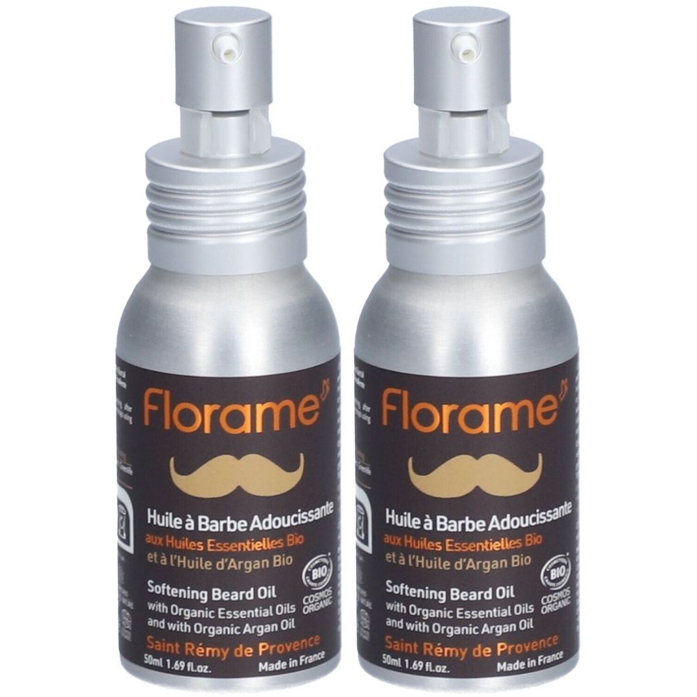 Twee flessen baardolie met verstuiver. Opschrift: Florame, Huile à Barbe Adoucissante, Bio-certificering. Zilverkleurige flessen met bruine etiketten.