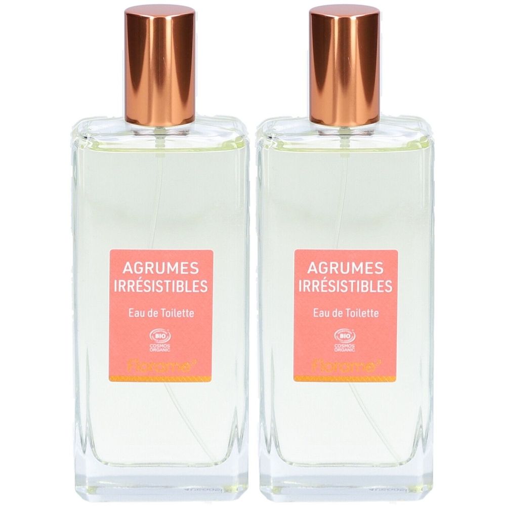 Deux flacons rectangulaires en verre avec des bouchons cuivrés. Étiquettes roses avec "Agrumes Irrésistibles Eau de Toilette".