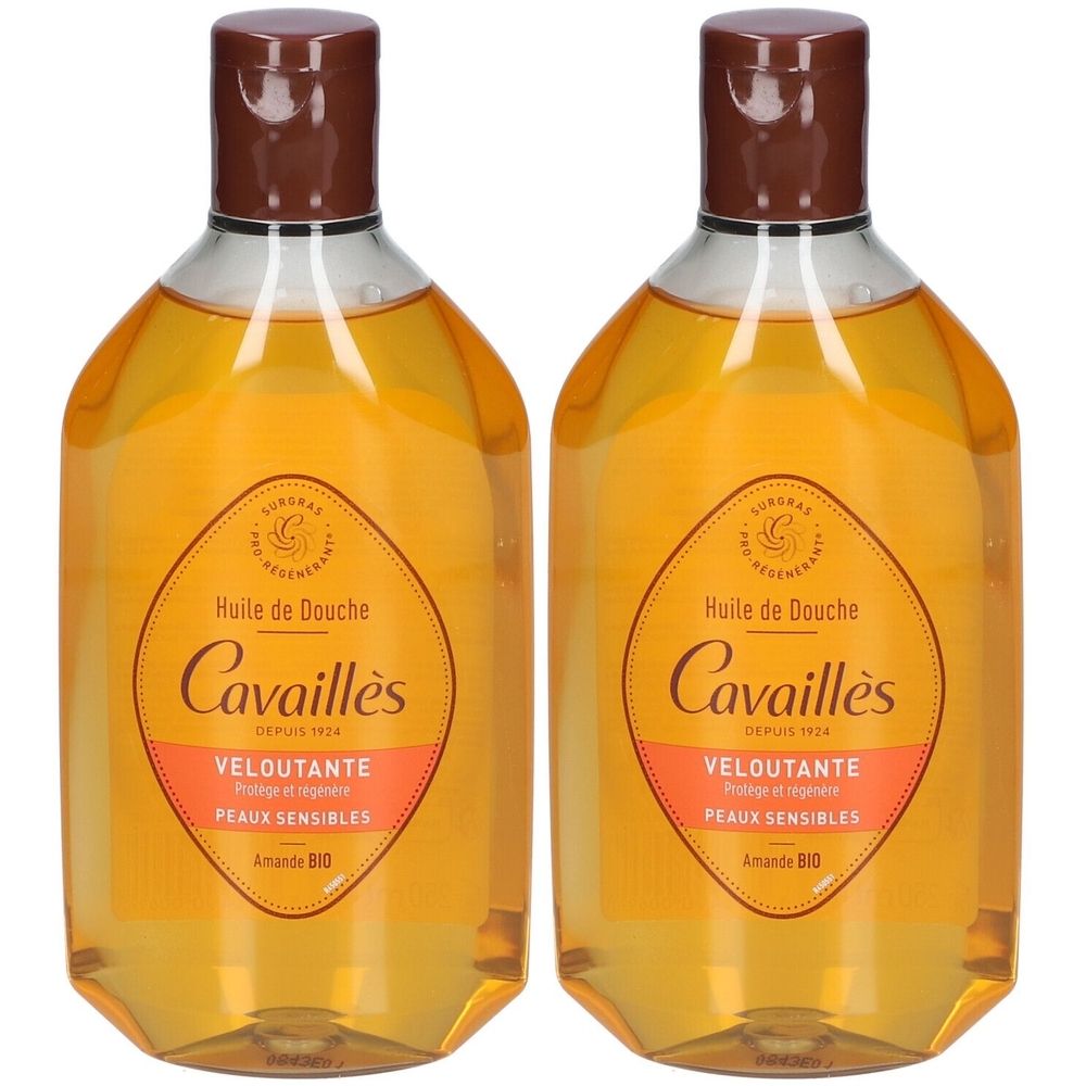 Twee flessen Rogé Cavaillès Huile de Douche Veloutante. Transparante flessen met bruine doppen en etiketten met productinformatie.