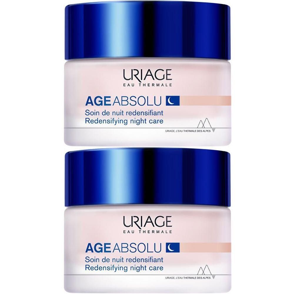 Twee potten Uriage Age Absolu nachtverzorging. Beige potten met blauwe deksels. Opschrift: Uriage, Age Absolu, Nachtverzorging.