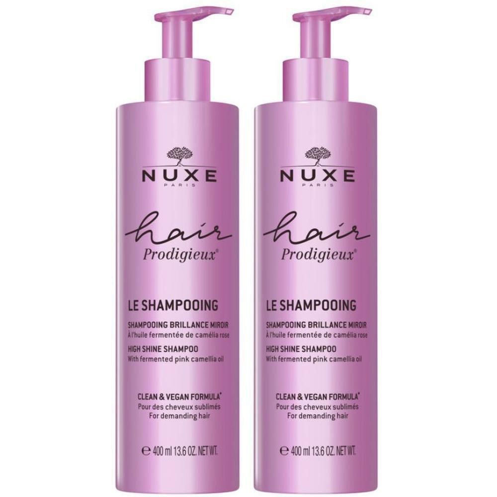 Twee roze shampoo flessen. Opschrift: Nuxe Hair Prodigieux, Le Shampooing, High Shine Shampoo. Met pomp.