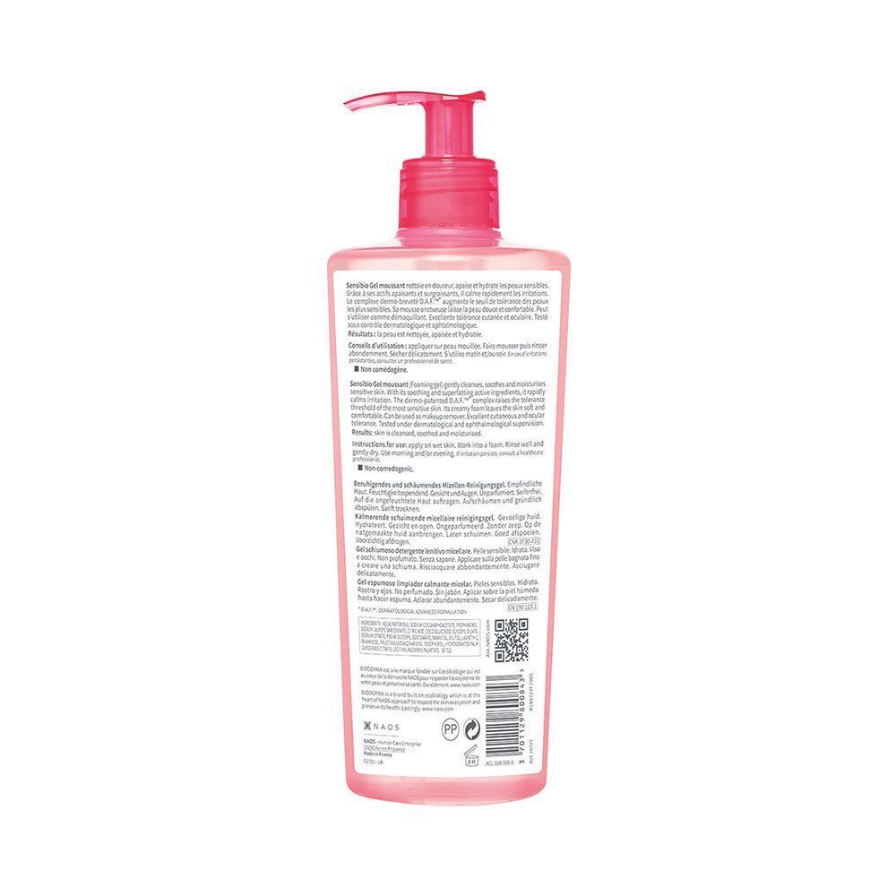 Flacon rose avec pompe doseuse, vue arrière. Texte multilingue, dont français, anglais et allemand.