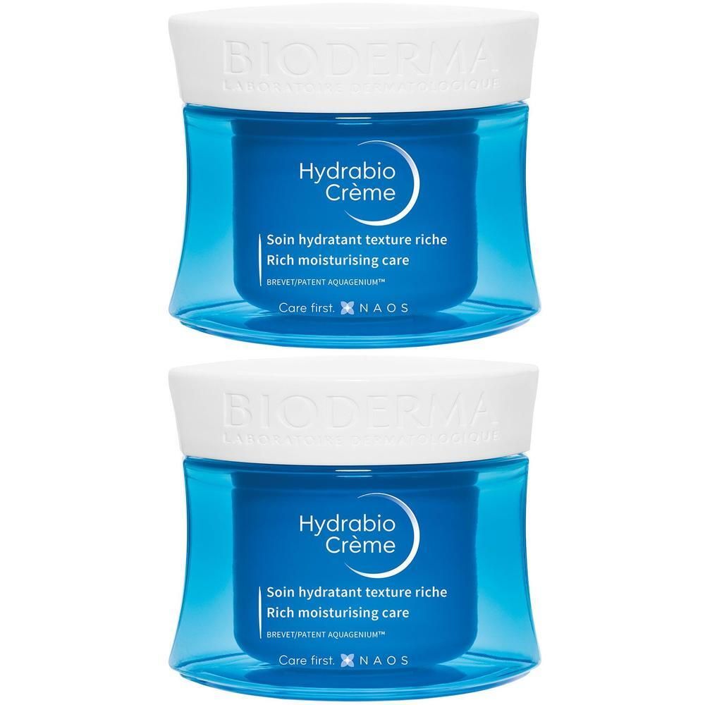 Deux pots bleus avec couvercles blancs. Inscription: Hydrabio Crème. Texte: Soin hydratant texture riche. Marque: Bioderma.