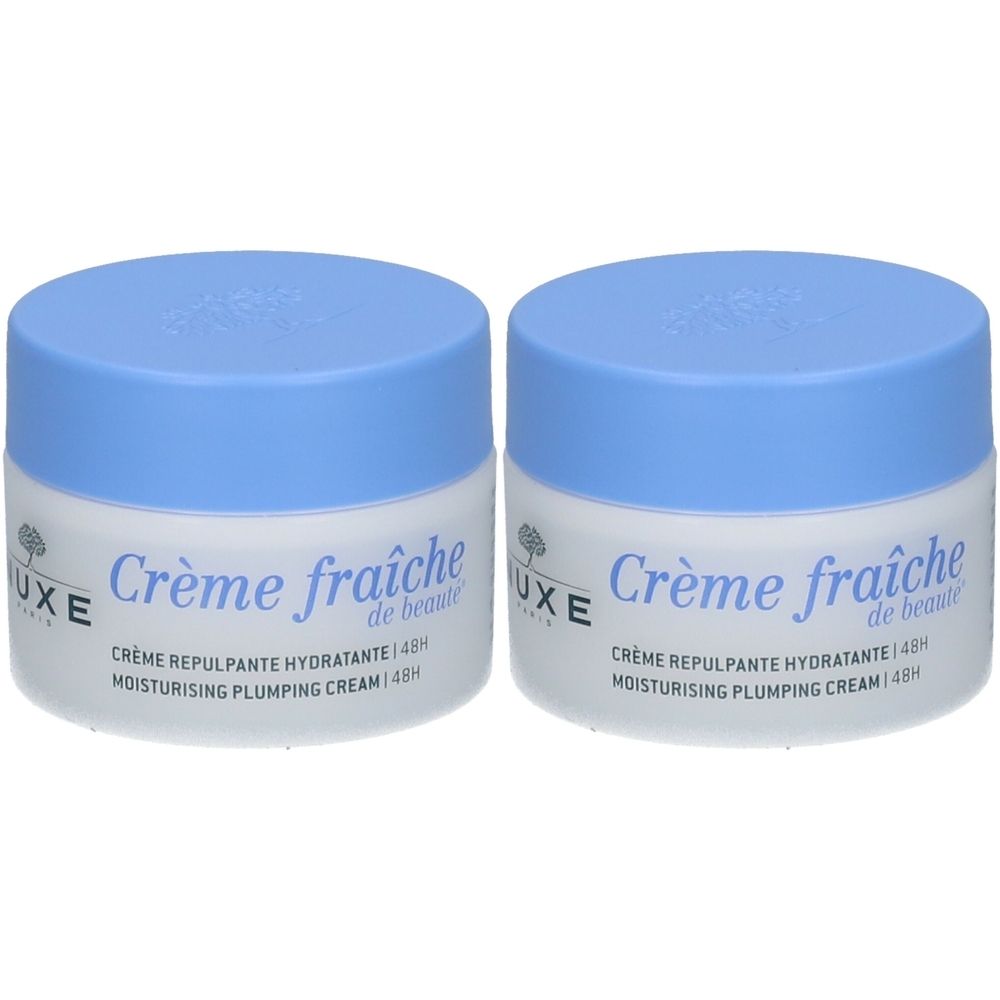 Deux pots de Nuxe Crème Fraîche de Beauté. Couvercles bleus, pots blancs. Inscription : Crème fraîche, Hydratante 48h.