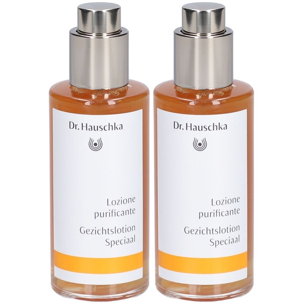 Twee flessen met zilveren doppen en etiketten. Opschrift: Dr. Hauschka, Lozione purificante, Gezichtslotion Speciaal.