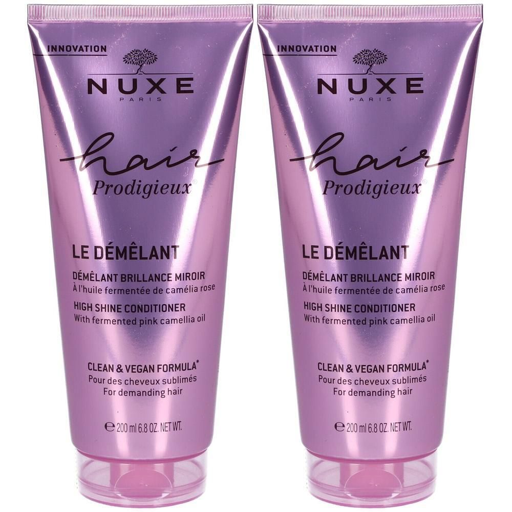 Twee tubes Nuxe Hair Prodigieux® Le Démêlant. Roze-paarse tint, tekst en productinformatie.
