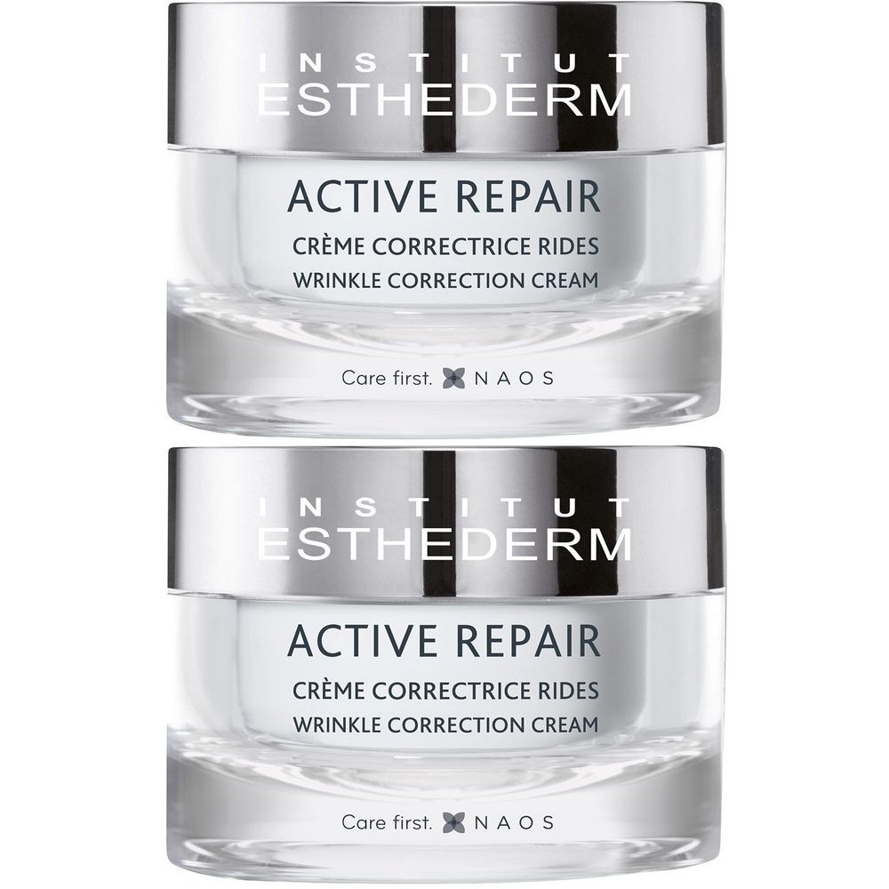Twee potjes INSTITUT ESTHEDERM Active Repair crème. Glazen potjes met zilverkleurige deksel. Tekst: ACTIVE REPAIR, Crème Correctrice Rides.