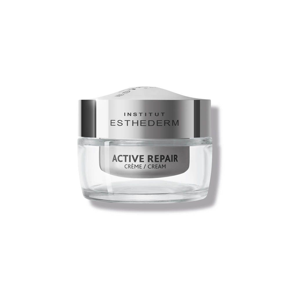 Un pot de crème INSTITUT ESTHEDERM Active Repair. Récipient en verre avec couvercle argenté. Texte: ACTIVE REPAIR, Crème / Cream.