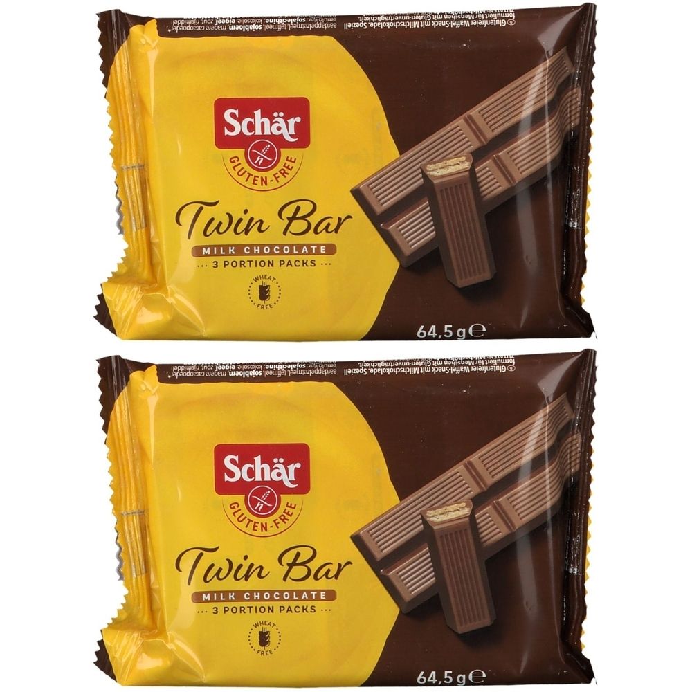 Twee verpakte Schär Twin Bar glutenvrij. Gele verpakking met bruine achtergrond. Opschrift: Twin Bar, melkchocolade, glutenvrij.