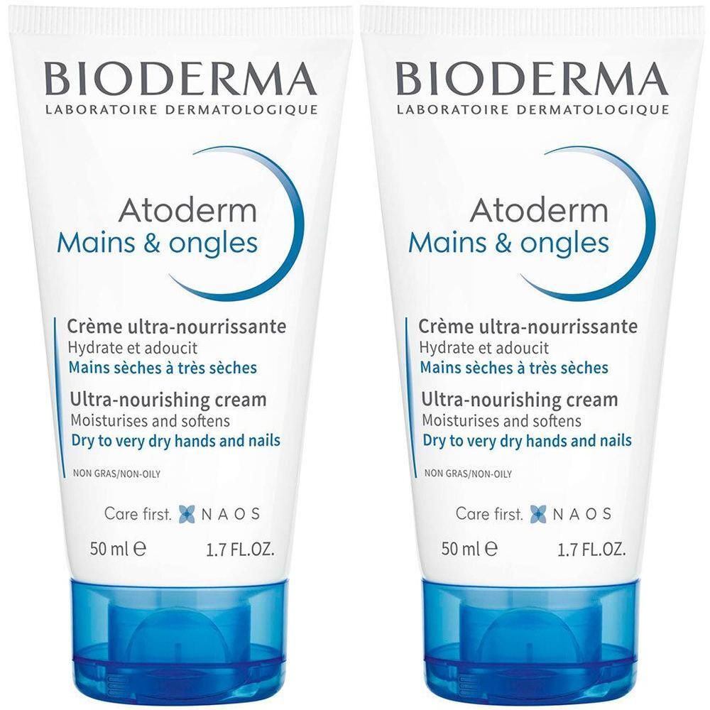Deux tubes de crème pour les mains BIODERMA Atoderm Mains & Ongles. Tubes blancs avec accents bleus. Texte : Crème ultra-nourrissante, 50 ml.
