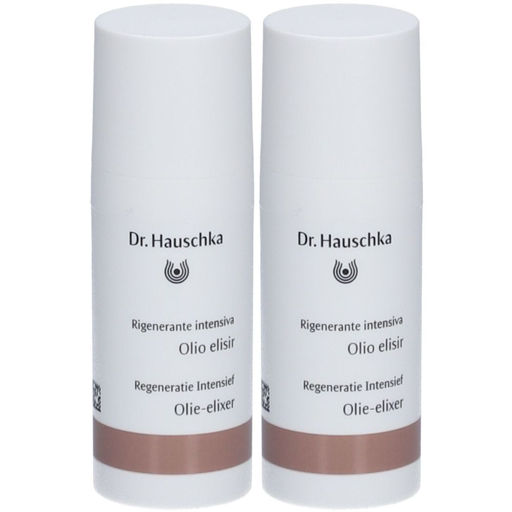 Deux flacons blancs avec base marron. Inscription: Dr. Hauschka, Rigenerante intensiva, Olio elisir, Regeneratie Intensief, Olie-elixer.