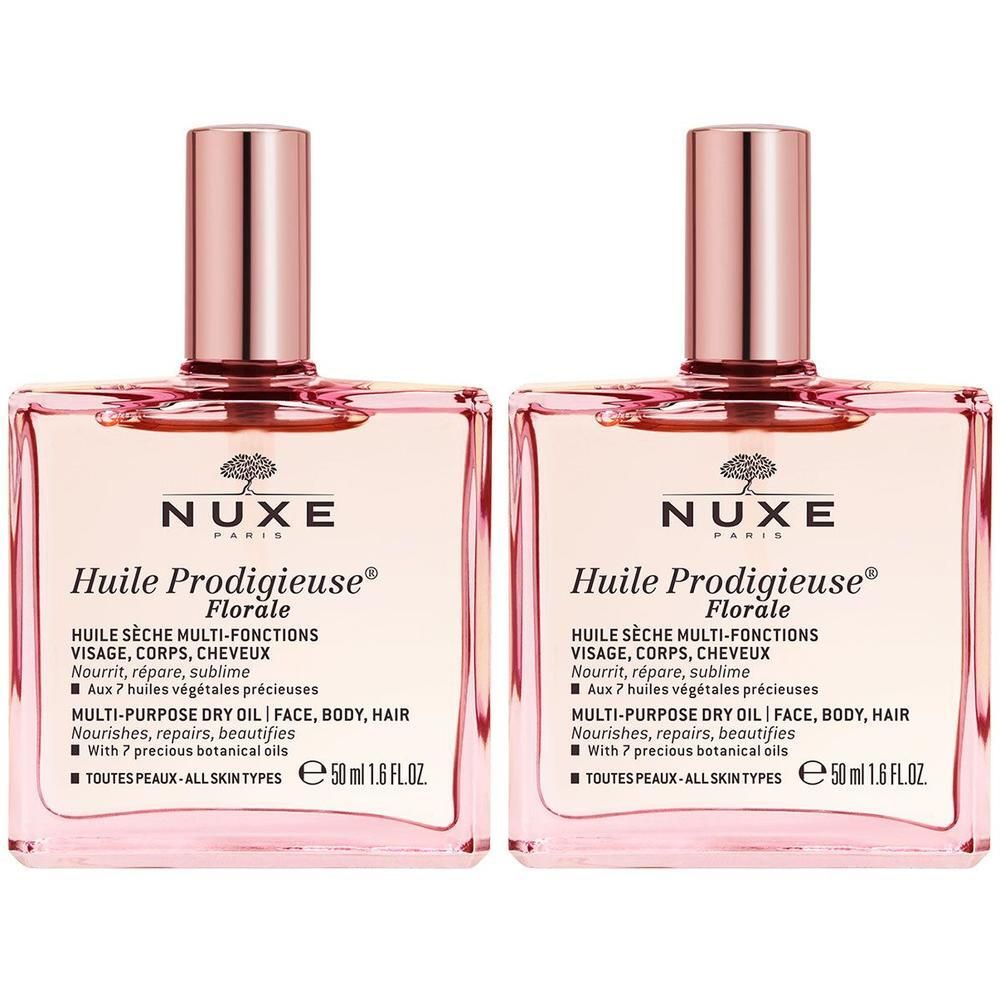 Twee vierkante flacons met roze vloeistof en roze doppen. Opschrift: Huile Prodigieuse® Florale. Naast elkaar.