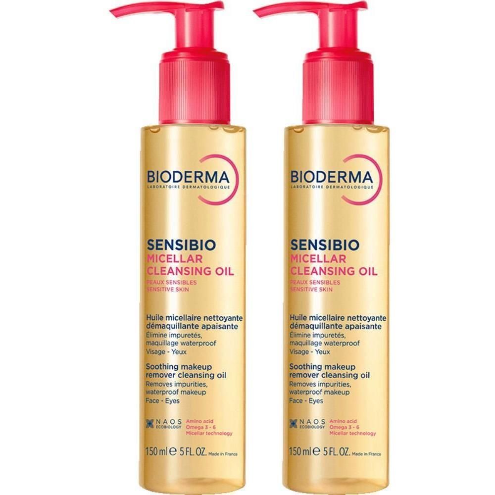 Twee flessen Bioderma Sensibio Micellar Cleansing Oil met roze pomp. Gele vloeistof, producttekst zichtbaar.