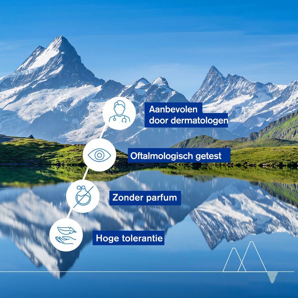 Landschap met bergen. Tekst: Recommandé par les dermatologues, Testé sous contrôle ophtalmologique, Non parfumé, Haute tolérance.