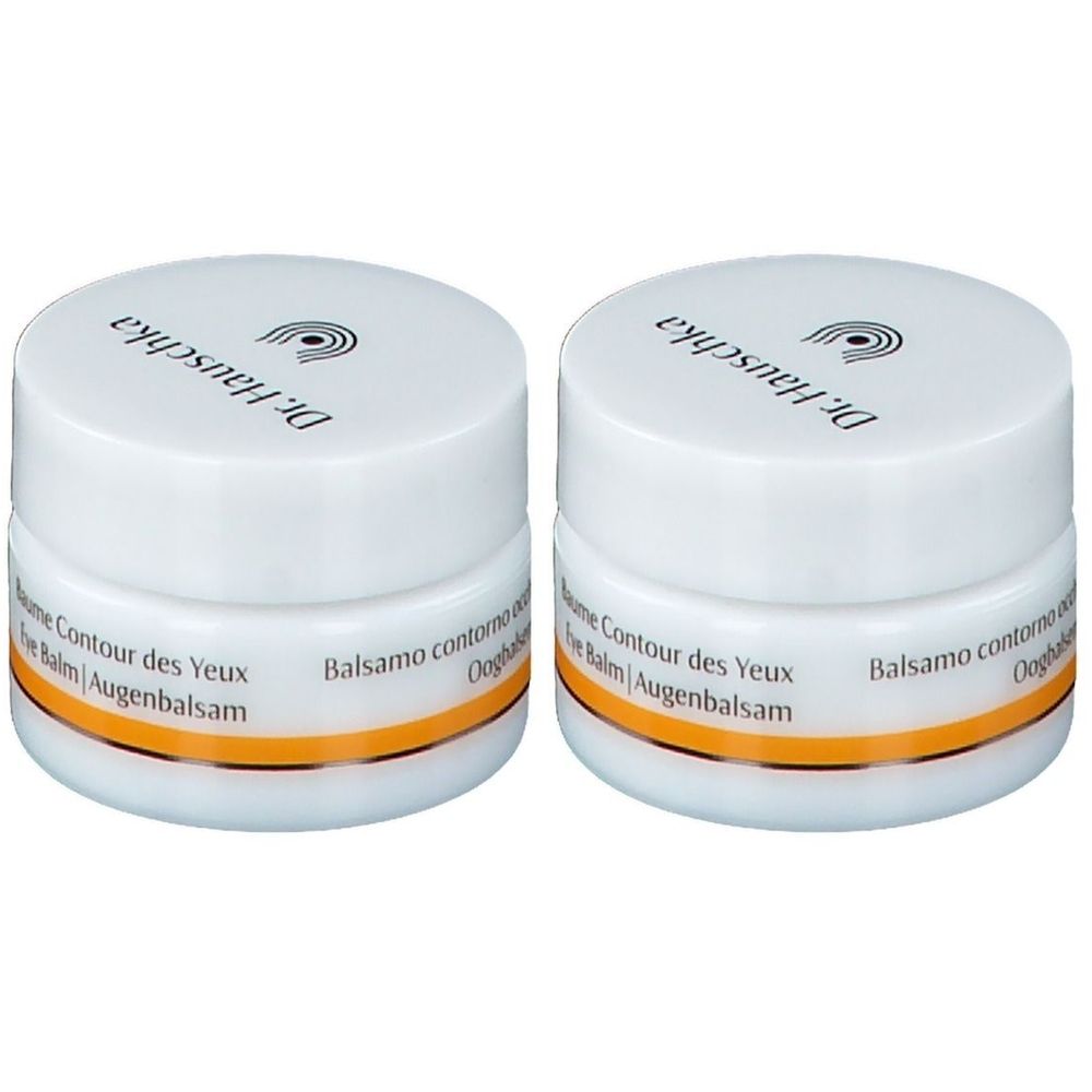 Twee witte potjes met deksels. Op het deksel staat « Dr. Hauschka ». Onder de deksel een gouden streep. Opschrift: « Baume Contour des Yeux Eye Balm Augenbalsam ».