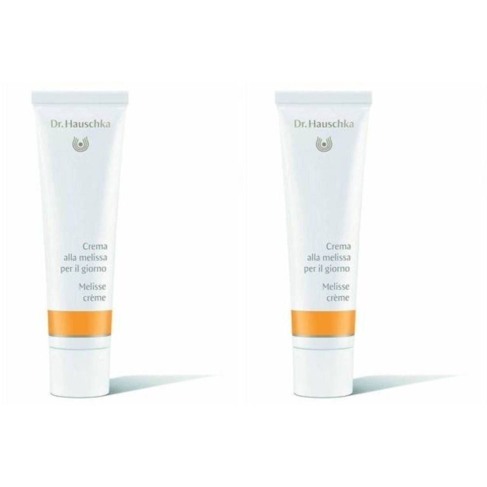 Twee tubes Crème à la Mélisse. Wit, met oranje band. Opschrift: Dr. Hauschka, Crema alla melissa, Melisse crème.
