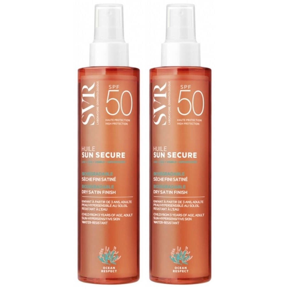 Twee flessen SVR Sun Secure Oil SPF50. Oranje flessen met witte spraykop. Tekst: SPF50, Sun Secure, Dry Satin Finish.
