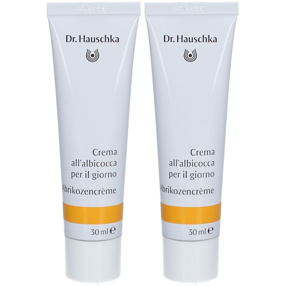 Twee crèmetubes op een witte achtergrond. Op elke tube staat "Dr. Hauschka" en "Crema all'albicocca per il giorno".