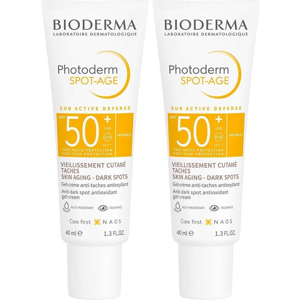Twee tubes Bioderma Photoderm Spot-Age SPF50+. Witte tubes met gele accenten. Tekst: SPF 50, Spot-Age, anti-aging.