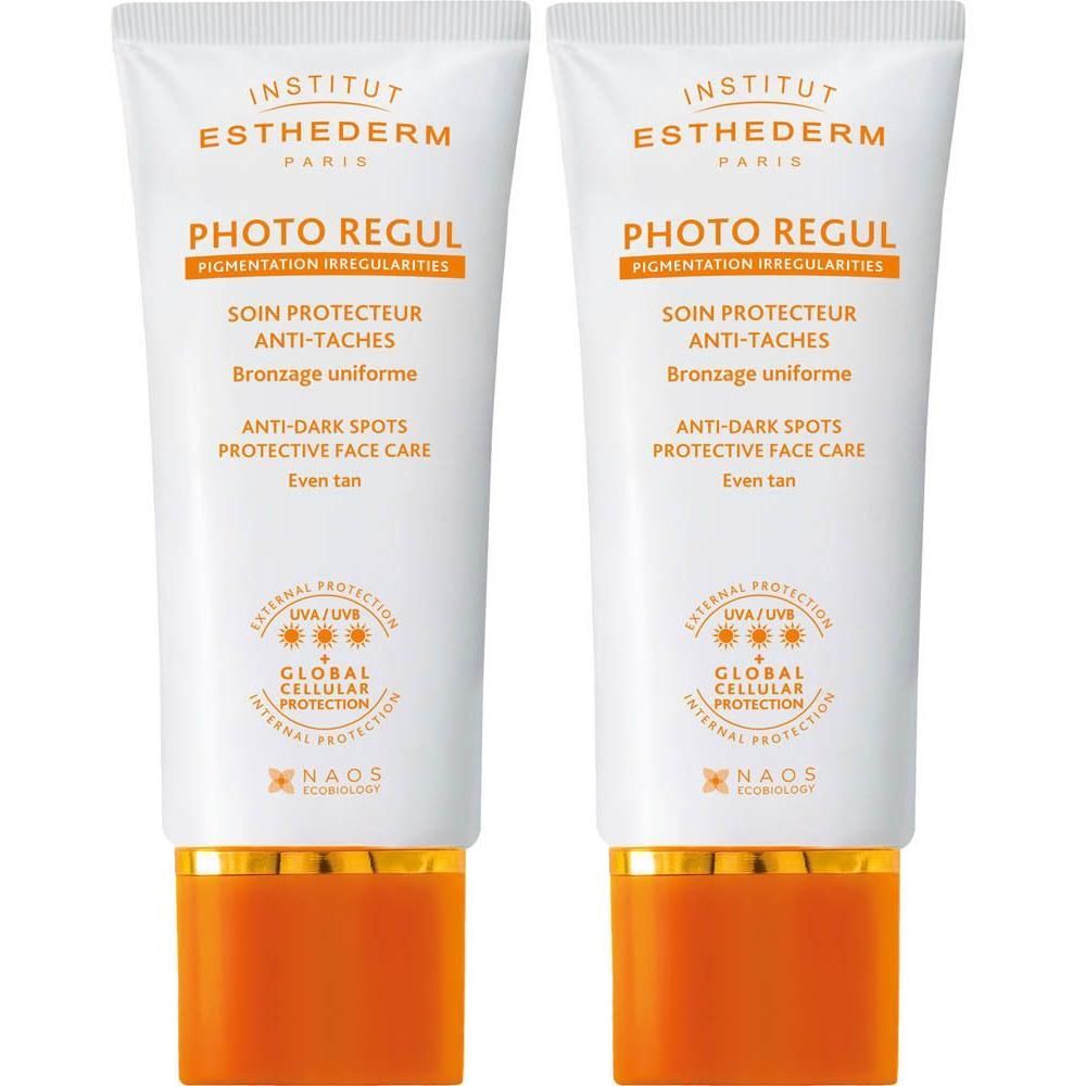 Twee tubes Institut Esthederm Photo Regul. Witte tubes met oranje en gouden elementen. Tekst: Photo Regul, Anti-Taches, NAOS.