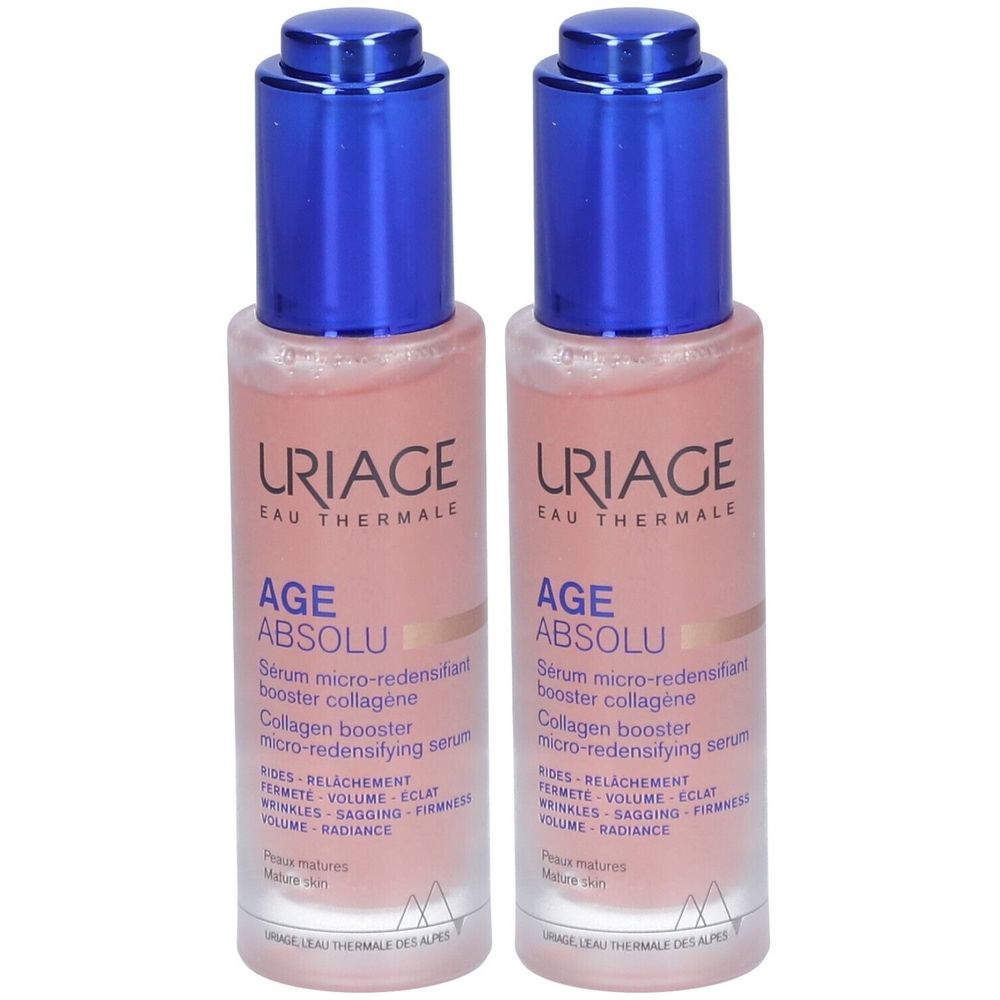Twee flessen Uriage Age Absolu serum. Roze vloeistof in glazen flessen met blauwe dop. Productnaam en merk zichtbaar.