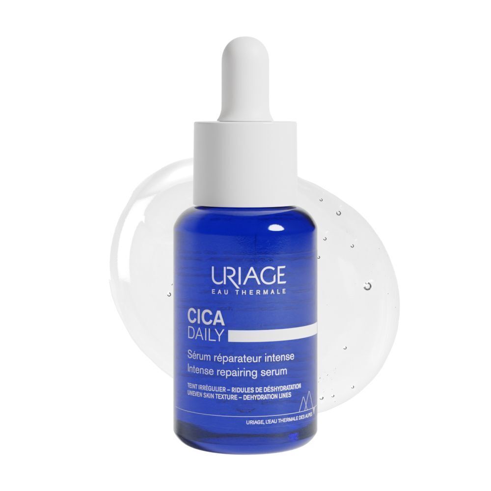 Flacon bleu avec bouchon blanc. Inscription: URIAGE, CICA DAILY, Sérum réparateur intense. Goutte de gel en arrière-plan.