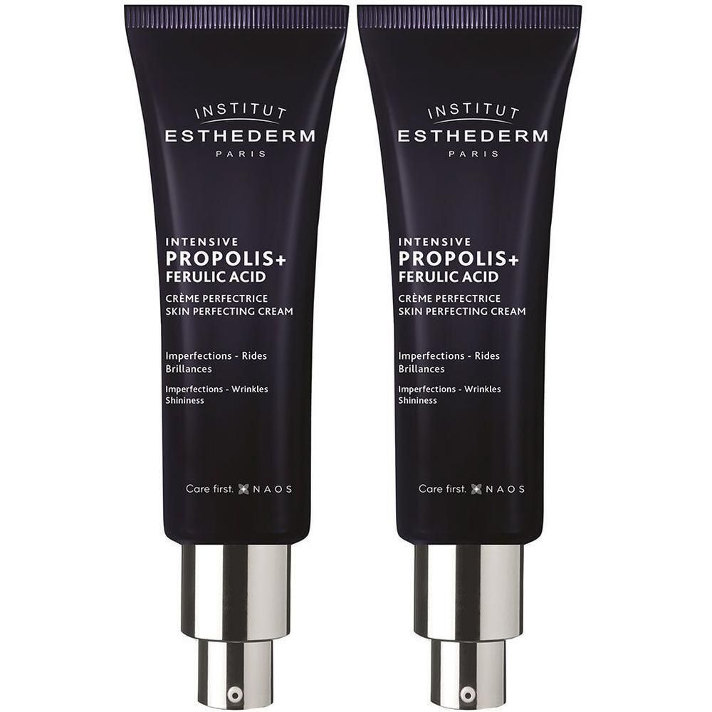 Twee crèmetubes. Donkerblauwe tubes met zilveren doppen. Tekst: INSTITUT ESTHEDERM, INTENSIVE PROPOLIS+ FERULIC ACID, Crème Perfectrice.