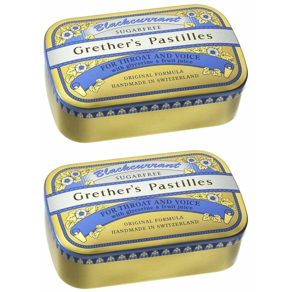 Twee goudkleurige pastillesdozen met blauwe en witte opschriften. Opschrift: Grether's Pastilles, Blackcurrant, suikervrij.