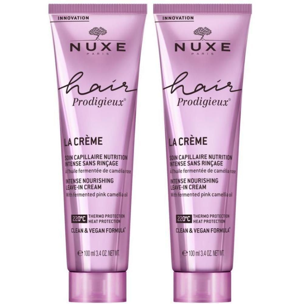 Twee tubes Nuxe Hair Prodigieux La Crème. Roze tubes met witte tekst. Productnaam en details.