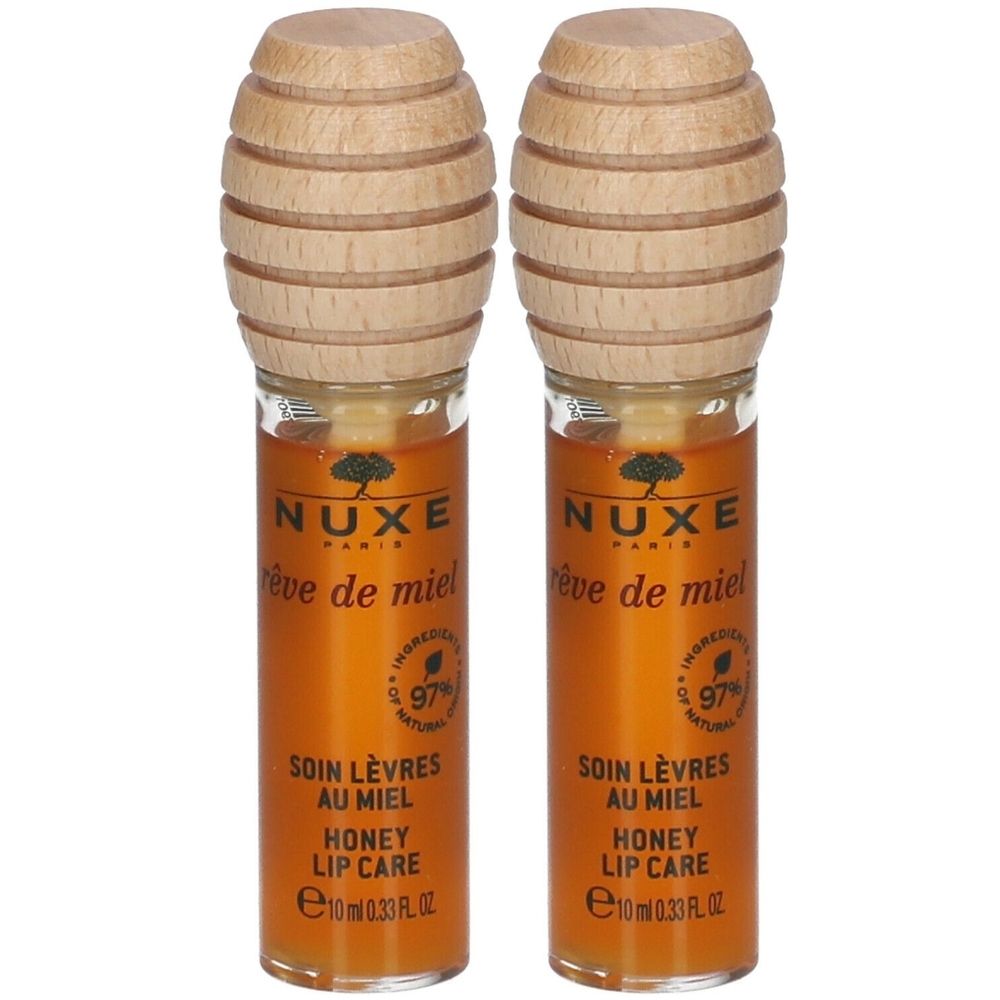 Twee lippenbalsem tubes met houten dop. Opschrift: NUXE, Rêve de Miel, Soin Lèvres au Miel, Honey Lip Care. 97% natuurlijke ingrediënten.