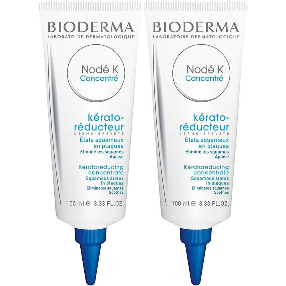 Deux tubes de BIODERMA Nodé K Emulsion. Blancs, embout bleu. Texte: Nodé K Concentré, kérato-réducteur.