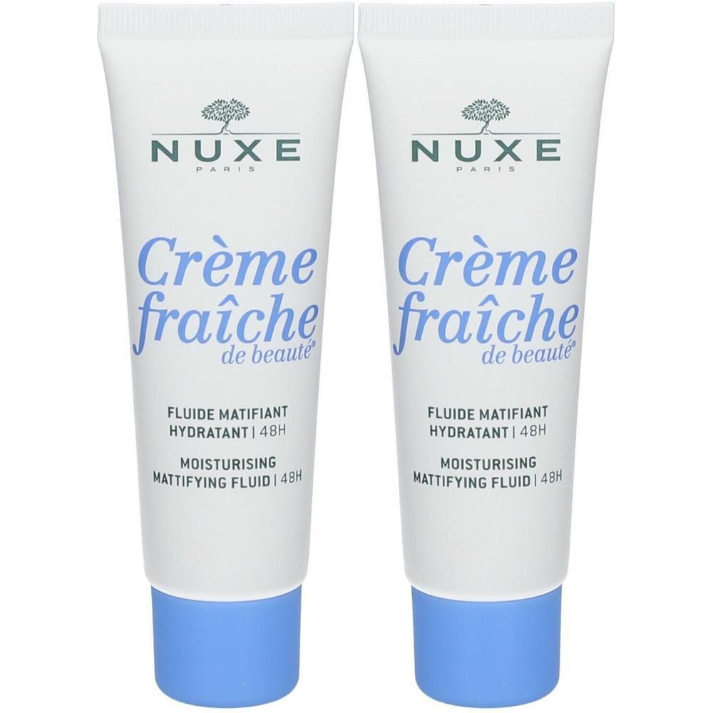 Twee tubes Nuxe Crème Fraîche de Beauté. Wit, blauwe dop, tekst zichtbaar. Productnaam en merk duidelijk zichtbaar.