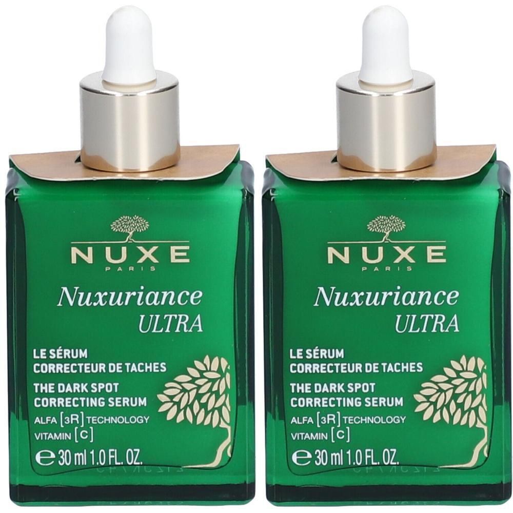 Twee groene glazen flacons met gouden doppen en pipetten. Opschrift: Nuxe Nuxuriance Ultra, Sérum Correcteur de Taches.